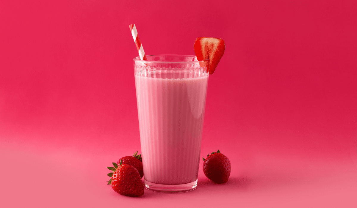 Blend together frozen strawberries, milk, and a dollop of vanilla ice cream